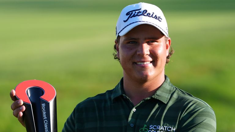 Aldrich Potgieter, of South Africa, poses with the trophy after winning a play-off at the PGA Tour's Rocket Classic