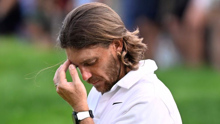 Tommy Fleetwood, from England, reacts as Keegan Bradley prepares to putt for the win during the final round of the Travelers Championship golf tournament at TPC River Highlands, Sunday, June 22, 2025, in Cromwell, Conn. At right is Fleetwood's caddie Ian Finnis. (AP Photo/Jessica Hill)